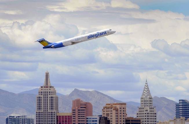 In this Thursday, May 9, 2013, photo, an Allegiant Air jetliner flies over the the the New York-New York Hotel & Casino after taking off from McCarran International Airport in Las Vegas.