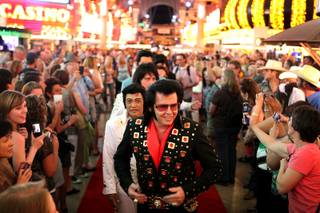 Sean Martin of Arcadia, Calif. waits with other Elvis tribute artists to walk the red carpet during the Las Vegas Ultimate Elvis Tribute Artist Contest on Friday, May 10, 2013 at the Fremont Street Experience in downtown Las Vegas.