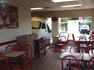 A van crashed through the front entrance of a KFC Friday after a collision with a pickup truck outside the restaurant on Friday afternoon, May 10, 2013.