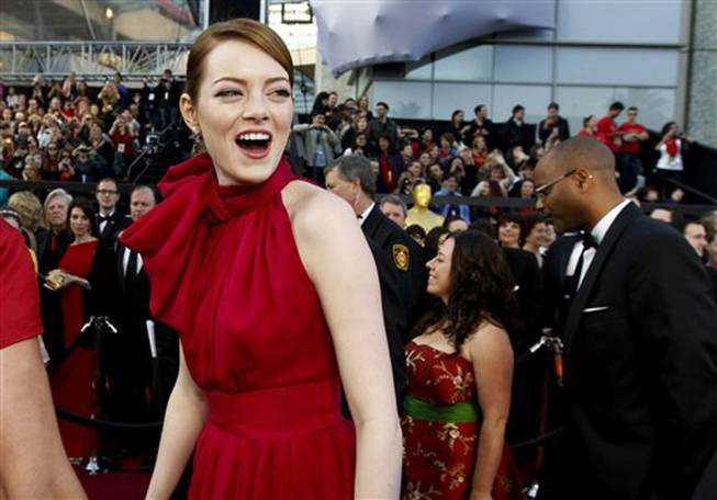 Emma Stone arrives before the 84th Academy Awards on Sunday, Feb. 26, 2012, in Los Angeles. (AP Photo/Chris Carlson)
