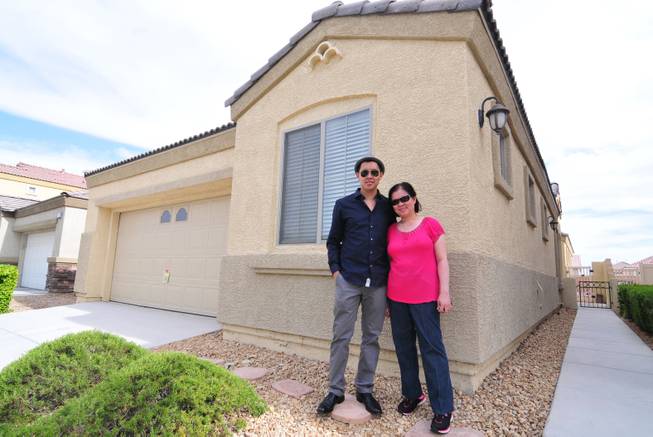 Michael Luangrath, 29, gave his mother, Dao Vahn, a longtime downtown Las Vegas business owner and cancer survivor, a $175,000 house for Mother's Day. The mother and son are shown here in a photo illustration of her house in North Las Vegas on Thursday, May 16, 2013.