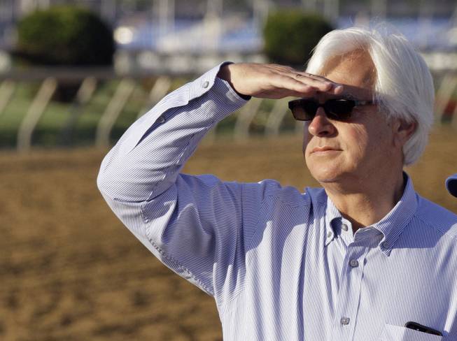 Hall of Fame trainer Bob Baffert looks for his Preakness Stakes entrant Governor Charlie during a morning workout at Pimlico Race Course on Friday, May 17, 2013, in Baltimore. The Preakness Stakes horse race is scheduled for Saturday.