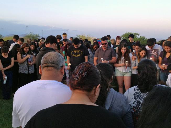 A candlelight vigil is held Friday, May 17, 2013, in remembrance of Bonanza High School freshman Marcos Vincente Arenas, who was killed when he was run over by an SUV driven by thieves who had targeted the teen.