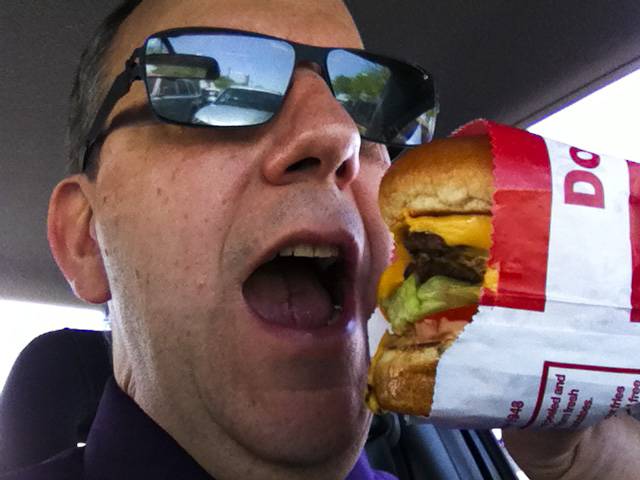 John Taylor enjoys an In & Out burger.