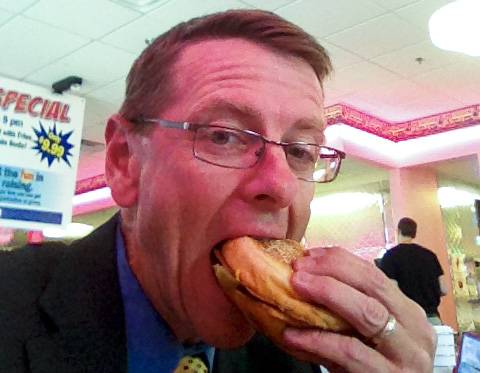 Ric Anderson enjoys a Cheeburger Cheeburger burger.
