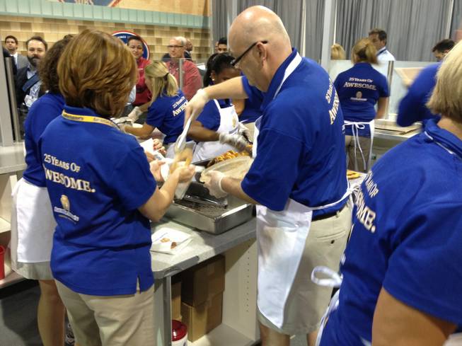 Auntie Anne’s staffers make fresh pretzels to serve at RECon, the retail industry trade show at the Las Vegas Convention Center, on May 20, 2013. Company officials expect to serve 12,500 pretzels during the convention.