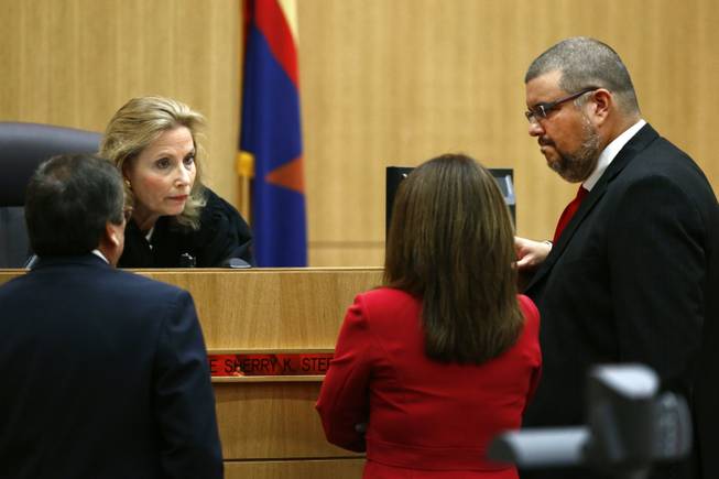 Judge Sherry Stephens meets with prosecutor Juan Martinez, left, and defense attorneys Jennifer Wilmott and Kirk Nurmi, right, after denying a motion for mistrial on Monday, May 20, 2013 during the penalty phase of Jodi Arias' murder trial at Maricopa County Superior Court in Phoenix, Ariz. Arias was convicted May 8, 2013 of first-degree murder in the stabbing and shooting to death of Travis Alexander, 30, in his suburban Phoenix home in June 2008.