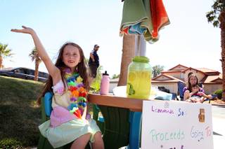 Gatlin Coleman, 7, sells lemonade to raise money for the Nevada Society for the Prevention of Cruelty to Animals outside her home on Sunday, May 26, 2013 in Henderson.
