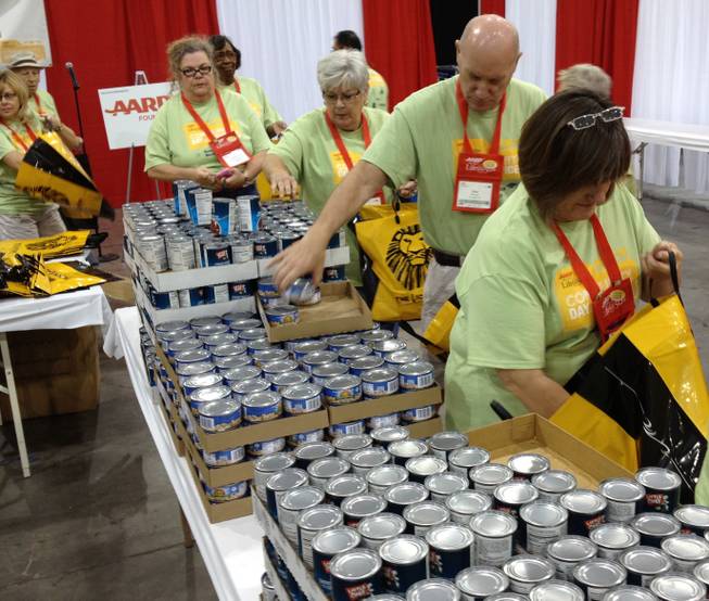AARP members in Las Vegas for a convention pack meals for Three Square.