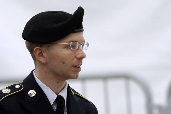 In this May 21, 2013, file photo, Army Pfc. Bradley Manning is escorted into a courthouse in Fort Meade, Md., before a pretrial military hearing.
