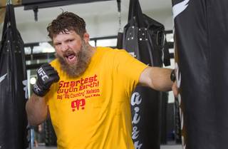 UFC heavyweight and Cimarron-Memorial grad Roy Nelson hits a bag at Gold's Gym, 7501 W. Lake Mead Blvd., Monday, June 10, 2013 in this file photo.