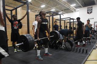 Football players use new equipment in the weight room at Chaparral courtesy of an anonymous donor Tuesday, June 11, 2013.