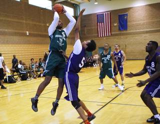 Jelan Kendrick shoots over Rashaad Muhammad during their game on the first night of the Desert Reign tournament Tuesday, June 18, 2013.