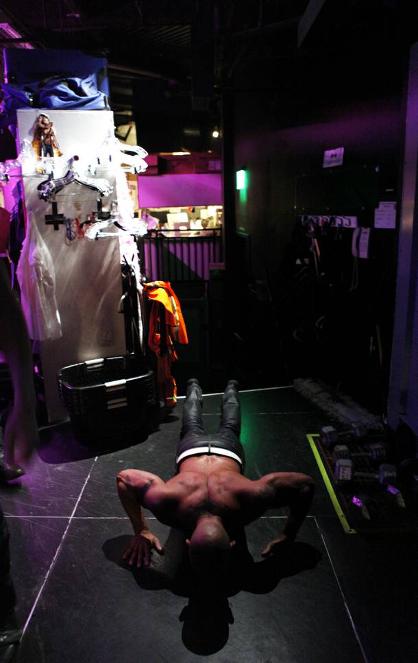 Chippendales dancer John Rivera does pushups backstage in the Chippendales backstage dressing area before their show on Tuesday, June 18, 2013 at the Rio in Las Vegas.
