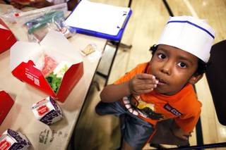 Dallas Spears, 5, eats his lunch during the Summer Food Service Program at the Heinrich YMCA in Las Vegas on Wednesday, June 19, 2013. The Summer Food Service Program is a federal nutrition program designed to feed children free, nutritious meals and snacks during the months of June, July, and August when school is out.