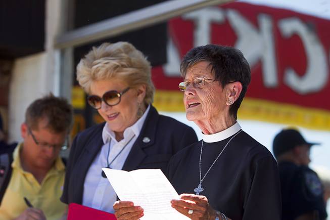 The Rev. Deacon Bonnie Polley gives an invocation during the grand reopening of The Atomic on East Fremont Street Wednesday, June 20, 2013. Las Vegas Mayor Carolyn Goodman listens at left. The bar was originally built in 1945 as Virginia's Cafe but was renamed Atomic Liquors in 1952 when patrons used to go to the roof to watch the nuclear blasts from the Atomic Test Site.