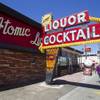 A pedestrian walks by The Atomic on East Fremont Street Wednesday, June 20, 2013. The bar was originally built in 1945 as Virginia's Cafe but was renamed Atomic Liquors in 1952 when patrons used to go to the roof to watch the nuclear blasts from the Atomic Test Site.