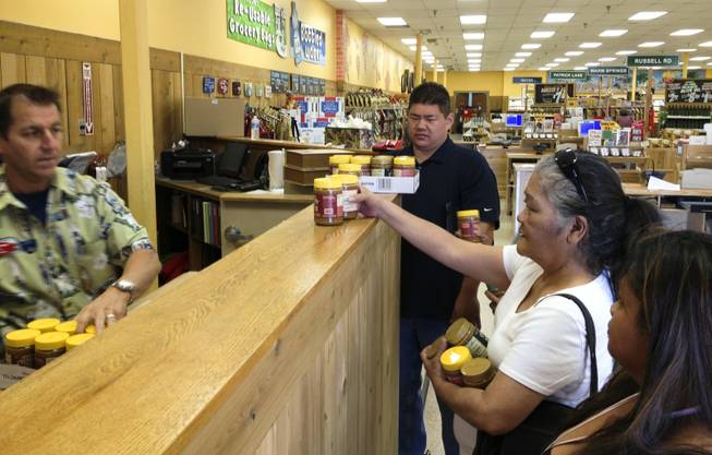 Shoppers pick up jars of the popular Speculoos Cookie Butter from the.manager's counter at Trader Joe's on Green Valley Parkway, June 21, 2013. At this and other Trader Joe's, the cookie butter is kept there to prevent people from rushing the aisles.