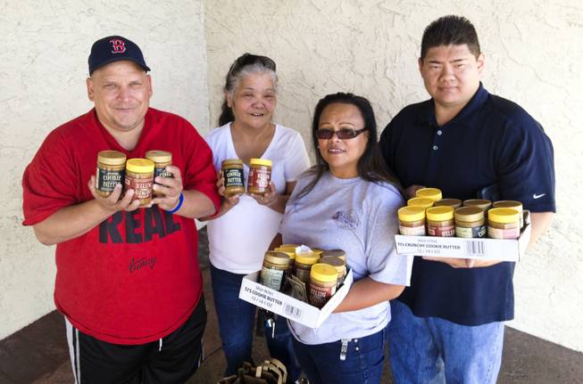 From left, Las Vegas Valley residents Eric Clay, Charlene Arellano, Rochelle Jiminez and Ricardo "Rico" Unzueta pose for a photo outside Trader Joe's on Green Valley Parkway June 21, 2013, holding jars of the popular Speculoos Cookie Butter they had just bought from the store.