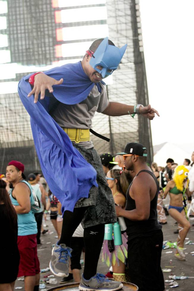 A fan dances on a barrel during the Headhunterz set at the Electric Daisy Carnival Festival, EDC, at the Las Vegas Motor Speedway, Sunday morning, June 23, 2013.