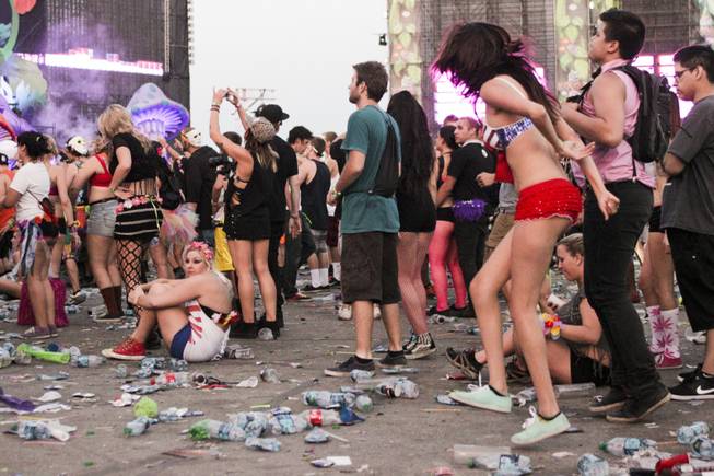 A fan sits down during the last act of the day, Headhunterz, at the Electric Daisy Carnival Festival, EDC, at the Las Vegas Motor Speedway, Sunday morning, June 23, 2013.