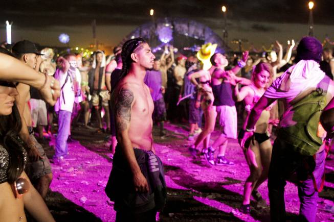 A fan watches the Dirtyphonic's set at the Electric Daisy Carnival Festival, EDC, at the Las Vegas Motor Speedway, Sunday morning, June 23, 2013.