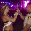 Sky Corona, 20 of La Habra, Calif. gives a bracelet to Metro Police Officer Pablo Torres during the third day of the Electric Daisy Carnival at the Las Vegas Motor Speedway early Monday morning, June 24, 2013.