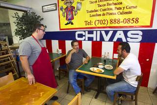 Giovanni Vargas, left, chats with customers Moses Murillo, left, and Marco Plascencia at the El Birotazo Mexican restaurant, 4262 E. Charleston Blvd., Wednesday, June 26, 2013. The restaurant owners are huge fans of the Chivas soccer team. Chivas (Guadalajara) and Club America (Mexico City), two of the most popular soccer teams in Mexico, play each other at Sam Boyd Stadium on Wednesday, July 3.