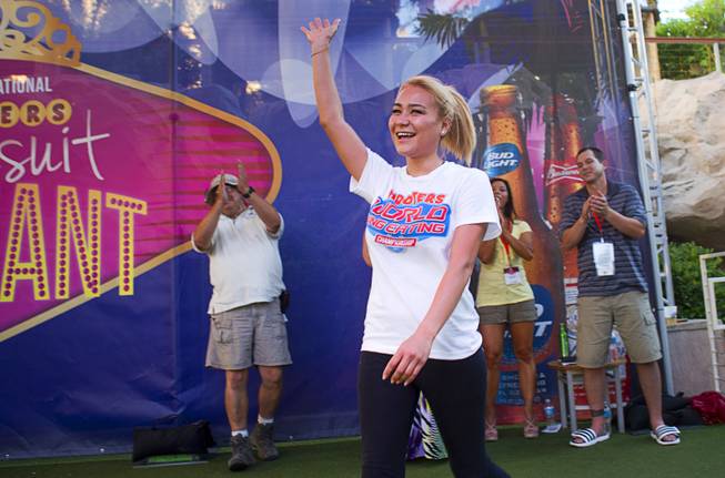 Las Vegas competitive eater Miki Sudo waves as she is introduced during a Hooters wing-eating contest at the Hard Rock Wednesday, June 26, 2013. Sudo won the competition, eating 192 wings in 10 minutes.