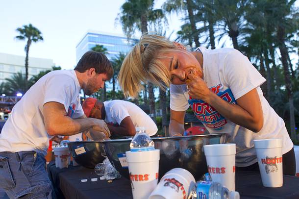Las Vegas competitive eater Miki Sudo, right, competes during a Hooters wing-eating contest at the Hard Rock Wednesday, June 26, 2013. Sudo won the competition, eating 192 wings in 10 minutes. Adrian 