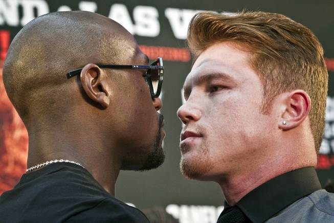 Floyd Mayweather Jr. faces off with Saul "Canelo" Alvarez during a boxing news conference Monday, June 24, 2013, at New York's Times Square. Mayweather Jr. and Alvarez kicked off an 11-city promotional tour, making their fight in Las Vegas on Saturday, Sept. 14, 2013, official.
