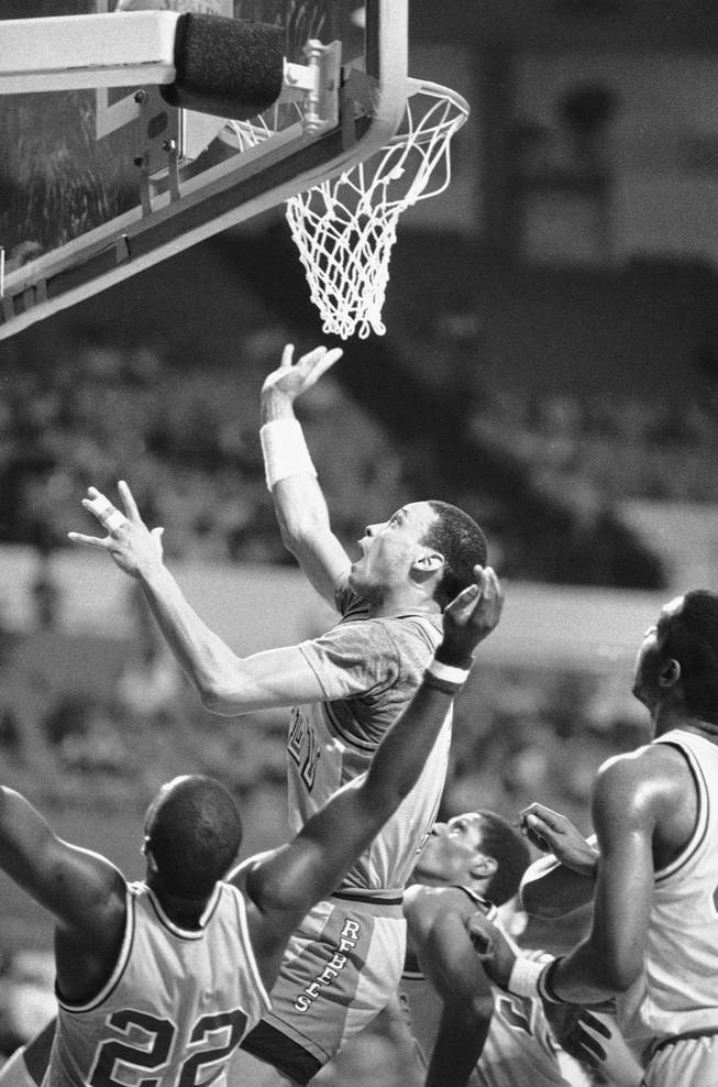 Anthony Jones, of the University of Nevada-Las Vegas goes up to make two points over Arthur Hayes, bottom, of Northeast Louisiana in the first half of the NCAA Basketball Championship, Friday, March 14, 1986, Long Beach, Calif. 