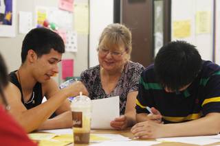 Teacher Jodi Wilde helps Alexander Gonzalez with a writing assignment during summer school class Friday, July 5, 2013 at Clark High School