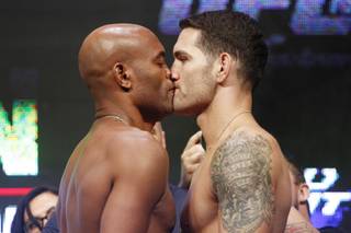 Anderson Silva and Chris Weidman touch lips as they face off during the weigh in for UFC 162 Friday, July 5, 2013 at the Mandalay Bay Events Center.