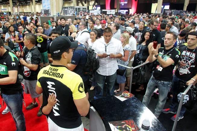A long line of fans wait to meet Lyoto Machida during the UFC Fan Fest at Mandalay Bay Friday, July 5, 2013.