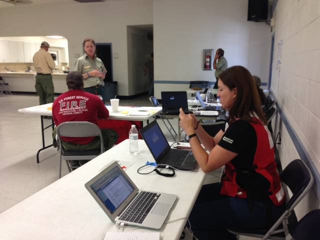 Jennifer Ramieh, a spokeswoman for the Southern Nevada Chapter of the American Red Cross, checks a Twitter account as a wildfire burns on Mount Charleston on July 5, 2013.