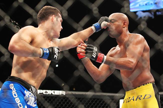 Chris Weidman tags Anderson Silva with a left during their middleweight title fight at UFC 162 Saturday, July 6, 2013 at the MGM Grand Garden Arena. Weidman upset Silva with a second round knockout, taking the belt Silva has held since 2006.