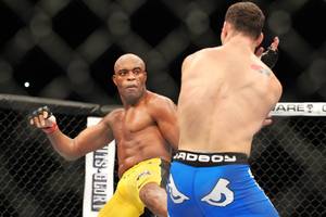 Anderson Silva throws a kick at Chris Weidman during their middleweight title fight at UFC 162 Saturday, July 6, 2013 at the MGM Grand Garden Arena. Weidman upset Silva with a second round knockout, taking the belt Silva has held since 2006.