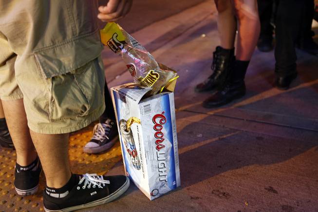 People with a case of beer hang out in the Fremont East District on Friday, July 5, 2013.