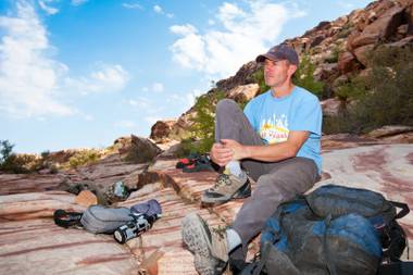 Simon Peck relaxes on the rocks prior to gearing up for a climb on the boulders at Calico Basin west of Red Rock Canyon Conservation Area in Las Vegas Saturday, July 6, 2013.