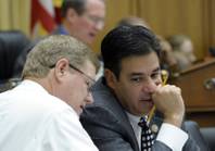 House Judiciary Committee members Rep. Raul Labrador, R-Idaho, right, and Rep. Mark Amodei, R-Nev. talk on Capitol Hill in Washington, Wednesday, May 22, 2013, during the committee's hearing on immigration reform.