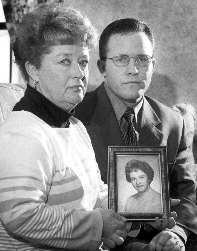 In this undated black and white file photo, Diane Dodd, left, and son Casey Sherman hold a photo in Rockland, Mass., of Dodd's sister Mary Sullivan, who was found strangled in January 1964 and is believed to have been the last victim of the Boston Strangler. Albert DeSalvo confessed to the string of 1960's killings but was never convicted. He died in prison in the 1970s. Massachusetts officials said Thursday, July 11, 2013, that DNA technology led to a breakthrough, putting them in a position to formally charge the Boston Strangler with the murder of Mary Sullivan.