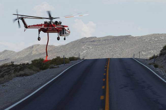 A Sikorsky Skycrane picks up a load of fire retardant near Kyle Canyon Road while fighting the Mt. Charleston fire Saturday, July 13, 2013.