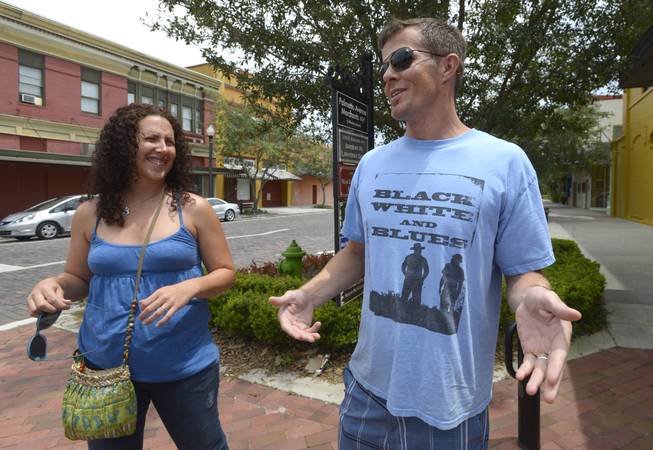 Kirk O'Neal, right, and Storey Book, of Orlando, Fla., talk about the outcome of the George Zimmerman trial while visiting the downtown area of Sanford, Fla., Sunday, July 14, 2013. Zimmerman, a former neighborhood watch volunteer, was found not guilty in the 2012 shooting death of Trayvon Martin.