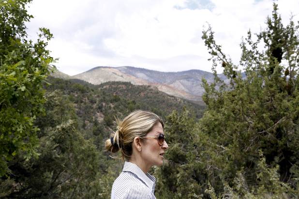 Kari Tillman stands at Torino Ranch, with the fire-scarred hills of Mount Charleston, damaged by a fire in 2002 and the recent Mount Charleston Fire seen in the distance on Monday, July 15, 2013. Last week, the Mount Charleston Fire came within one mile of Torino Ranch, which is located in Lovell Canyon on the Pahrump side of Mount Charleston in the Spring Mountains National Recreation Area.