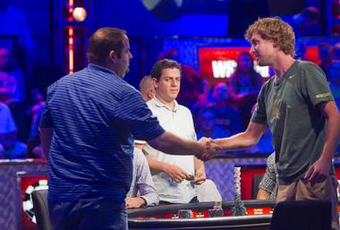 Ryan Riess, right, of East Lansing, Mich. shakes hands with Rep Porter of Woodinville, Wash. after knocking Porter out of the World Series of Poker $10,000 buy-in no-limit Texas Hold ‘Em main event at the Rio Tuesday morning, July 16, 2013.