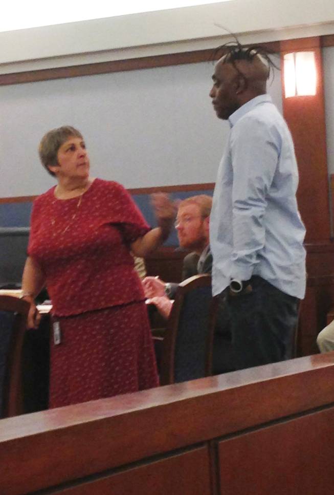 Laurie Diefenbach of the Clark County Public Defender's Office talks with rapper Coolio during his court appearance on a domestic violence charge. Diefenbach showed Coolio the deal offered by the prosecution as a friend of the court. Coolio refused the offer and was given 30 days to decide if he would like to represent himself in the case.