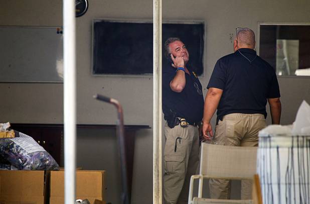 Homeland security investigators confer during a raid at warehouse space behind the Power Exchange sex club on Highland Drive Wednesday, July 17, 2013. 