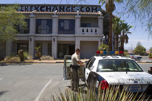 A Metro Police officer prepares to leave the Power Exchange sex club on Highland Drive Wednesday, July 17, 2013. Homeland Security investigators raided a warehouse space behind the Power sex club.