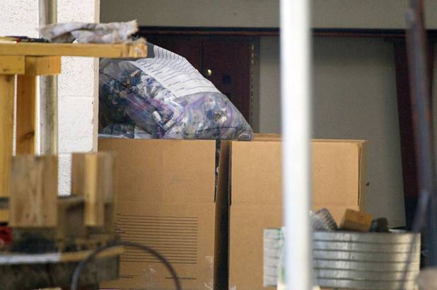 Evidence is stacked in bags and boxes during a Homeland Security raid at a warehouse space behind the Power Exchange sex club on Highland Drive Wednesday, July 17, 2013.